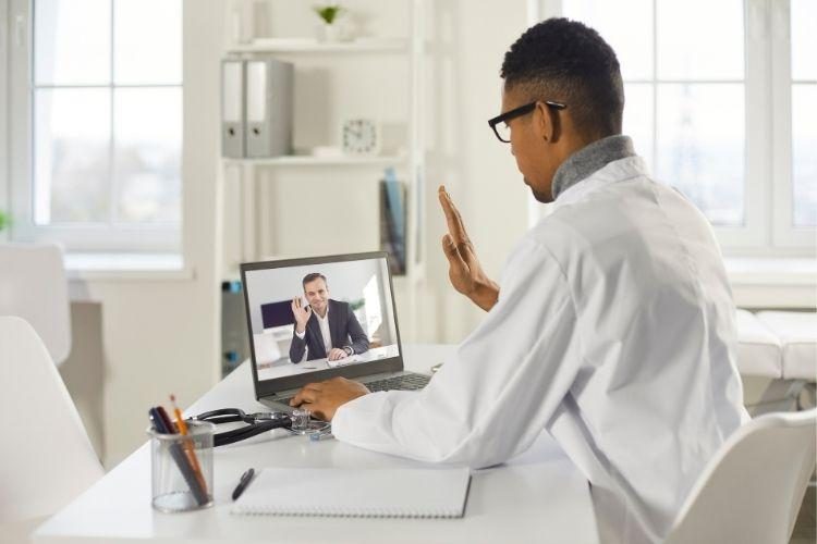 Telehealth worker talking to patient on laptop